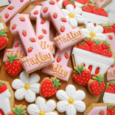 decorated cookies with the letters i - y and strawberry's on them are displayed