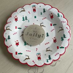 a paper plate decorated with santa claus and reindeers on it, that says be jolly