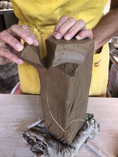 a person is making something out of clay