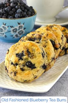 three blueberry tea muffins on a white plate