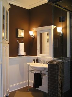 a bathroom with brown walls and white fixtures