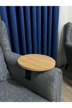 a wooden table sitting on top of a blue couch