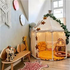 a child's play tent with lights and decorations on the walls in a children's room