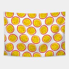 an orange pattern on a white wall hanging from a metal rod with red and yellow circles