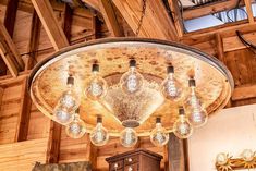 a chandelier hanging from the ceiling in a room with wooden walls and ceilings