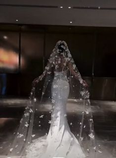 a woman in a wedding dress covered in water