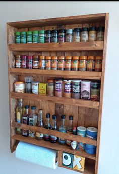 a wooden spice rack filled with lots of spices