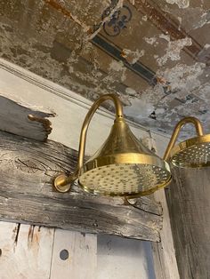 an old light fixture hanging from the ceiling in a room with peeling paint on it