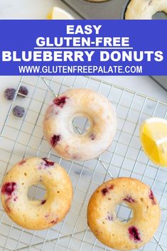 three blueberry donuts on a cooling rack with lemons and cherries in the background