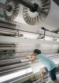 a woman is working on an assembly line