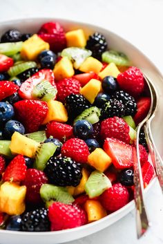 a white bowl filled with mixed fruit salad