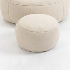 two white round poufces sitting on top of each other