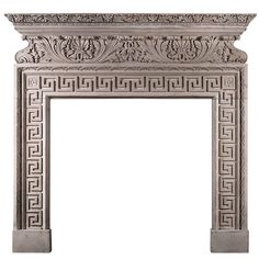 an ornate stone fireplace surround with intricate carvings on the top and sides, in white marble