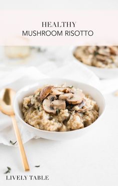 mushroom risotto in a white bowl with spoons on the side and text overlay