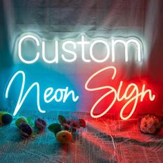 a neon sign that says custom neon sighn on top of a bed with stuffed animals