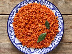 a blue and white plate topped with red rice