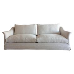 a white couch with two pillows on it