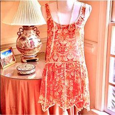 Never Worn, Gorgeous Fp Sleeveless Dress In An Exquisite Orange, Red & Bone Damask Floral Print With All-Over Delicate Lace Trim & A Flowy Handkerchief Hemline. Very Flirty & Feminine Style, Lightweight, Loose & Airy Relaxed Fit. Semi-Sheer, Best With A Lace Bralette & Stunning With Ivory Leggings Or Under A Lightweight Jacket. Featuring A Deep Scoop Neck Front & Back, Dropped Waistline, Lace Trim Accents & Multi-Pointed Handkerchief Hem. 100% Polyester. Approx. Bust 18”, Length 35”. Nwot Flowy Sleeveless Orange Mini Dress, Flirty Feminine Style, Ivory Leggings, Red Bone, Lace Slip Dress, Handkerchief Hem, Lace Slip, Lace Bralette, Lightweight Jacket