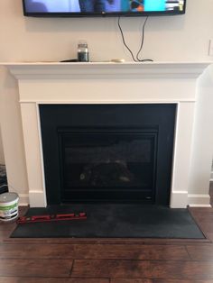 a flat screen tv mounted above a fireplace