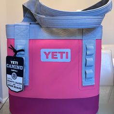 a pink and blue cooler bag sitting on top of a table