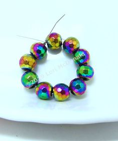 multicolored glass bead bracelet on a white plate