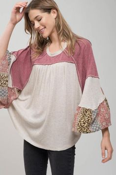 Patchwork Sleeve Blouse This casual blouse features a flowy knit style with a contrasting pattern detail on the sleeves. #bohemianstyle #bohemianfashion #bohoblouse #bohoapparel #hippielifestyle #hippieshirt #patchworkblouse #patchworktop Bohemian Textured Knit V-neck Top, Multicolor Tops With Elastic Sleeves For Spring, Stretch Patchwork Tops For Layering, Flowy Tops With Elastic Sleeves For Fall, Cotton Blouse With Flutter Sleeves For Fall, Bohemian 3/4 Sleeve Tops For Fall, Bohemian 3/4 Sleeve Fall Tops, Casual Multicolor Tops With Striped Sleeves, Knit Tops With Striped Long Sleeves