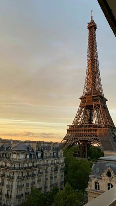 the eiffel tower towering over paris at sunset