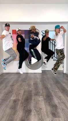 a group of young men standing on top of a wooden floor