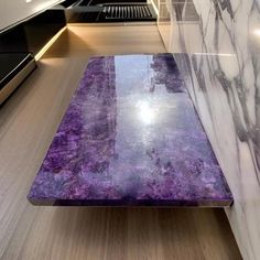 a purple marble table in the middle of a room