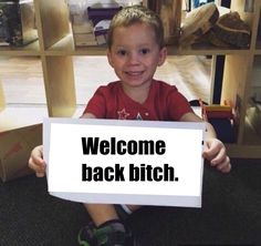 a young boy sitting on the floor holding a sign that says delete your account