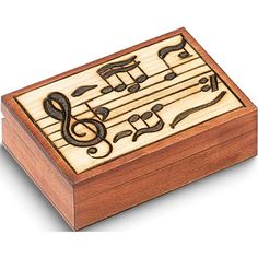 a wooden music box with musical notes on it