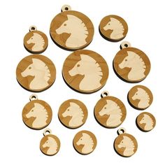 twelve wooden horse head medallions on white background