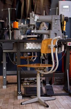 a wooden chair sitting in front of a machine