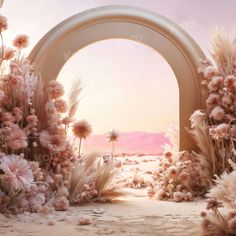 an arch with flowers and grass in front of it, as the sun goes down