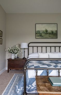 a bedroom with a metal bed frame and blue bedspread