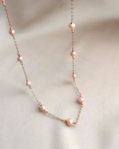 💗 Delicate Rose Gold Pearl Necklace with pink freshwater pearls & 14K Rose Gold Filled ✨ Dainty & Elegant. Simply beautiful necklace/ choker. A perfect gift & affordable treat for yourself.• Pearl size: 4-5 mm• Model picture is wearing 15" in length (model is 155 cm/ 5'1" height)• Handmade with genuine pink Freshwater Pearls. All metal parts are high-quality 14K Rose Gold Filled. It also can be made with 14K Gold-filled or Sterling Silver.• Gold-filled chain is known for its lasting quality. Th Pink Pearl Necklace Rose Gold, Delicate Pearl Necklace, Rose Gold Pearl Chain Necklace, Rose Gold Single Strand Necklace For Anniversary, Rose Gold Single Strand Pearl Necklace, Elegant Rose Gold Pearl Necklace With Delicate Chain, Feminine Rose Gold Necklace With Pearl Chain, Feminine Rose Gold Pearl Chain Necklace, Feminine Rose Gold Necklace For Anniversary