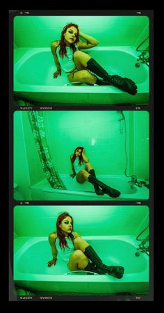 a woman sitting in a bathtub with her legs crossed and wearing black boots, posing for the camera