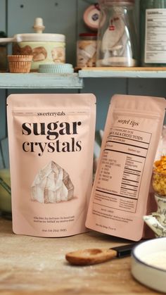 two bags of sugar crystals sitting on top of a counter