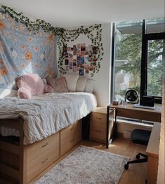 a bedroom with a bed, desk and hanging tapestry in the corner on the wall