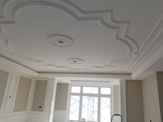 an empty room with white walls and ceiling