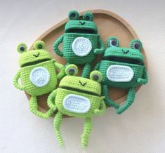 crocheted frog family on a wooden plate with text describing the different types of frogs