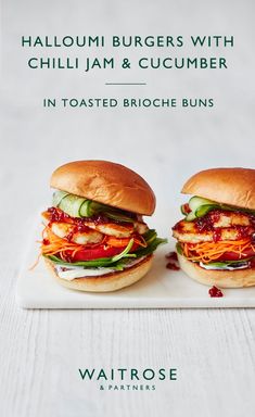 two burgers with chilli jam and cucumber in toasted brioche buns