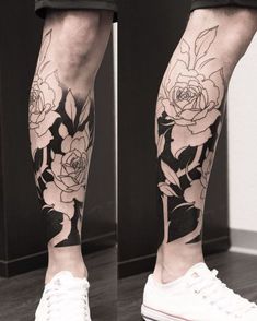 a person with flowers on their legs and one leg has a flower tattoo on it