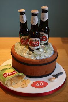 a cake made to look like a barrel with beer bottles on top