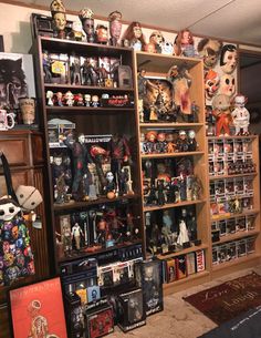 a room filled with lots of halloween figurines and bookshelves on shelves