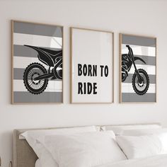 two framed posters on the wall above a bed