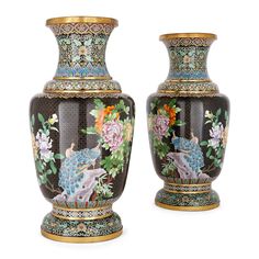 two vases with colorful designs on them sitting next to each other in front of a white background