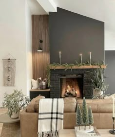 a living room filled with furniture and a fire place covered in candles next to a fireplace