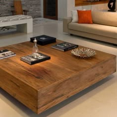 a coffee table with books on it in a living room