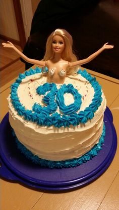 a birthday cake with a barbie doll on top